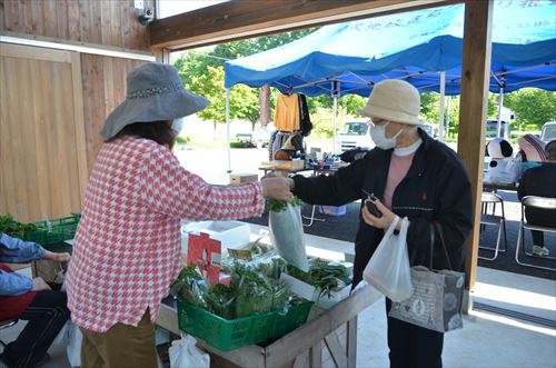 会計が終わり、商品を手渡される女性