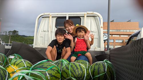 親子とスイカの写真