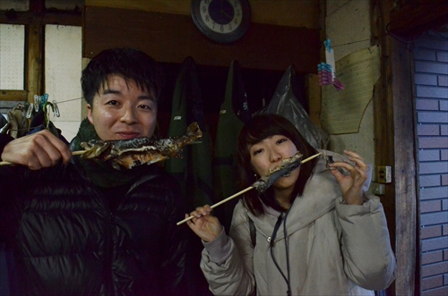 イワナをかじる人々の写真