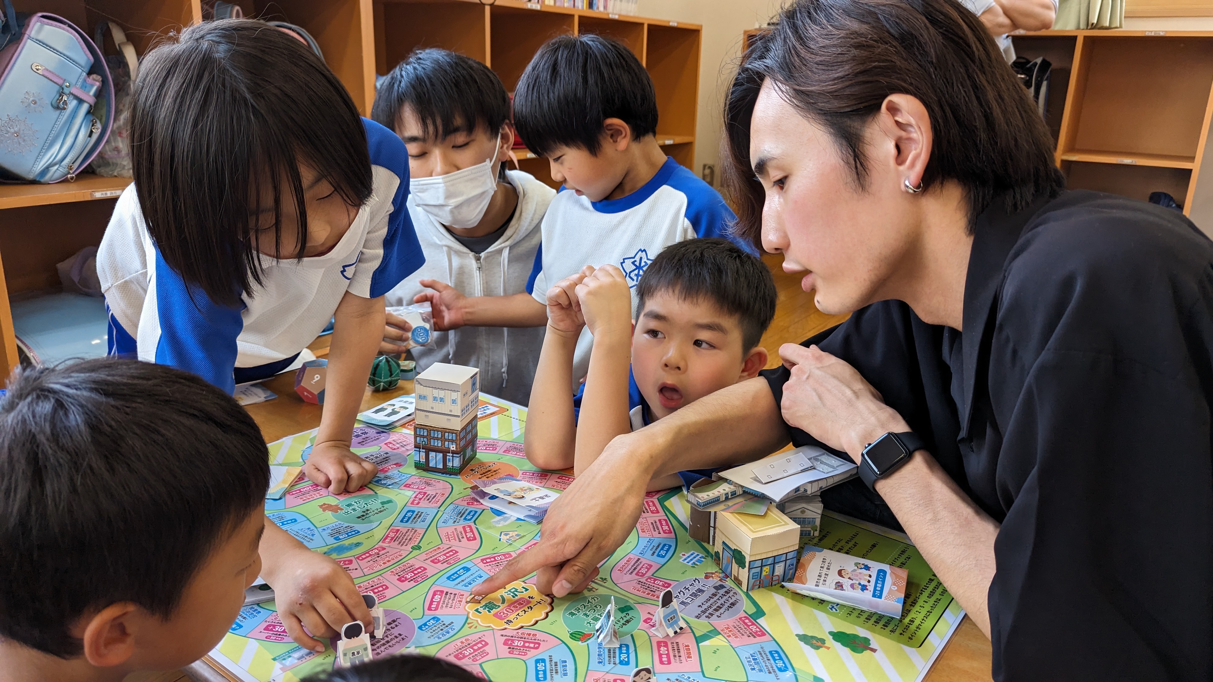 ひだまりキッズクラブ一本木で子どもたちがすごろくを遊んでいる様子